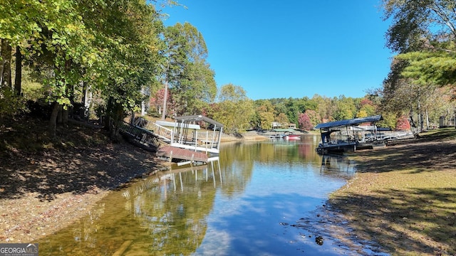 exterior space with a dock and a wooded view