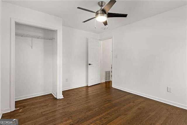 unfurnished bedroom with dark hardwood / wood-style floors, a closet, and ceiling fan