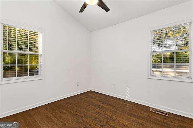 unfurnished room with ceiling fan, vaulted ceiling, and dark hardwood / wood-style flooring