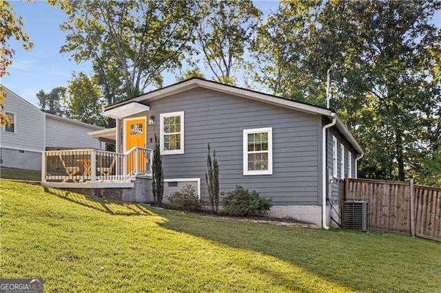 exterior space featuring central AC and a yard