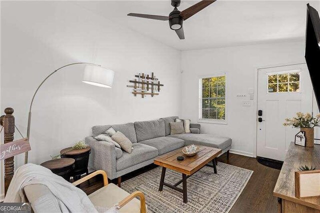 living room featuring dark hardwood / wood-style floors and ceiling fan