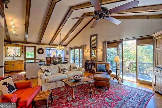 842 Saddleback Cir Unit 36, Sky Valley, GA 30537 - living room with beamed ceiling, high vaulted ceiling, wood finished floors, a ceiling fan, and a chandelier