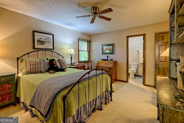 bedroom with light carpet, a textured ceiling, connected bathroom, and ceiling fan