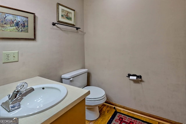 bathroom featuring vanity, toilet, and wood-type flooring