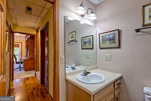 bathroom with vanity, toilet, and hardwood / wood-style floors