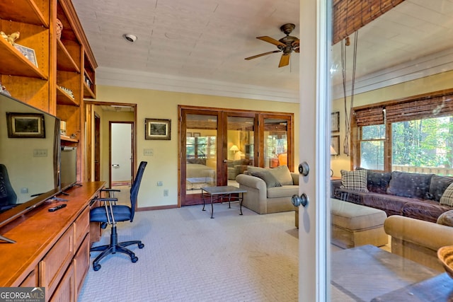 office area with light colored carpet, built in desk, and ceiling fan