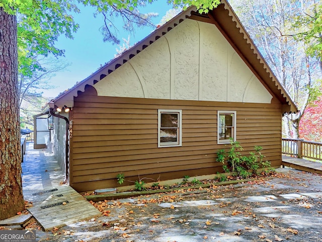 view of side of property featuring a deck