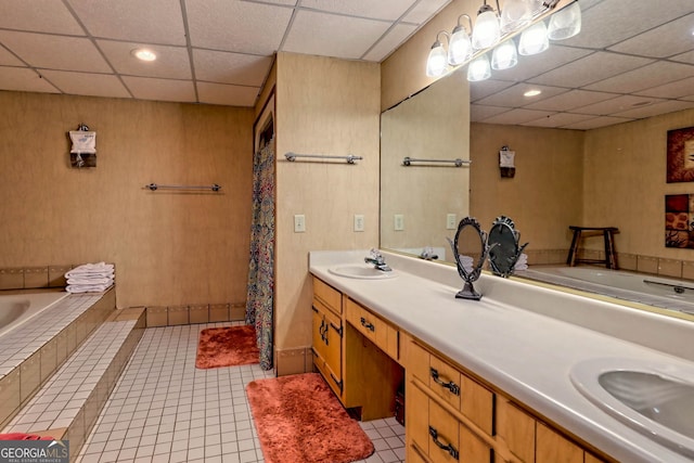 bathroom with vanity, a paneled ceiling, a bath, and tile patterned floors