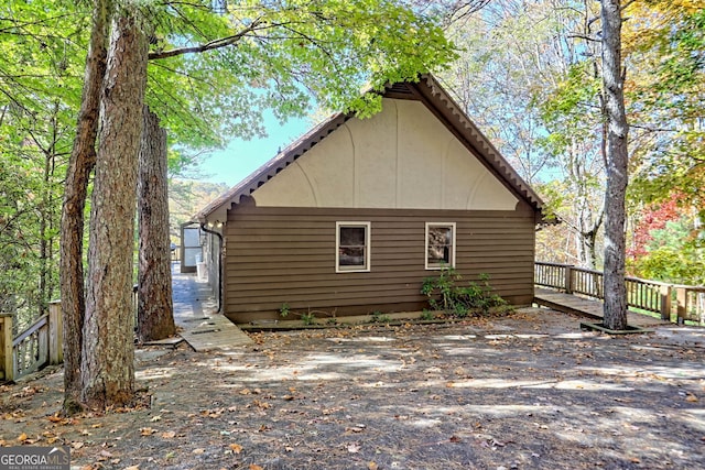 view of side of property featuring a wooden deck