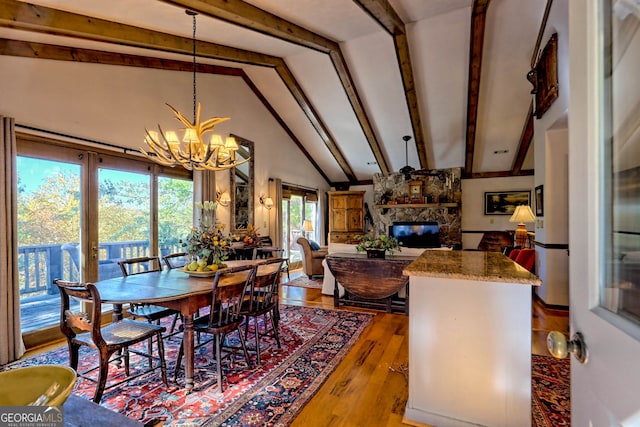 842 Saddleback Cir Unit 36, Sky Valley, GA 30537 - dining room with a chandelier, wood finished floors, and a stone fireplace