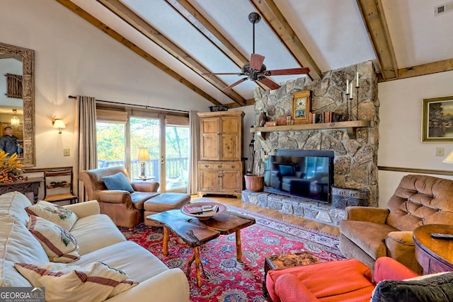 living room with a stone fireplace, beam ceiling, hardwood / wood-style floors, high vaulted ceiling, and ceiling fan