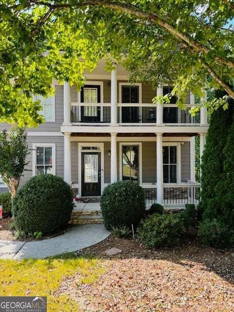 view of front of house with covered porch and a balcony