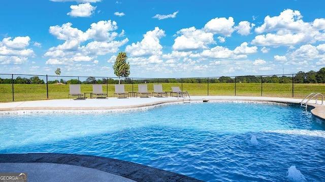 view of swimming pool featuring a lawn