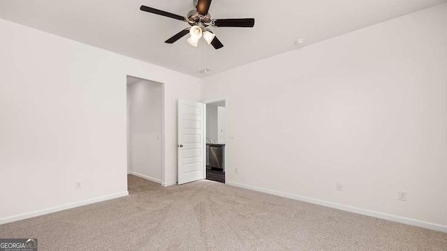 empty room featuring light colored carpet and ceiling fan