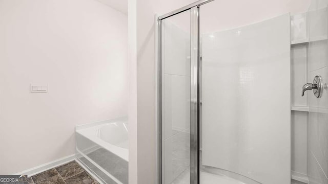 bathroom with separate shower and tub