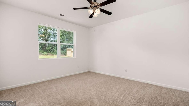 carpeted spare room featuring ceiling fan