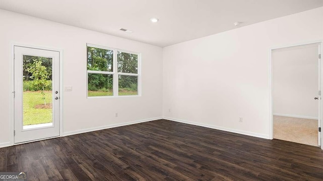 unfurnished room featuring dark wood-type flooring