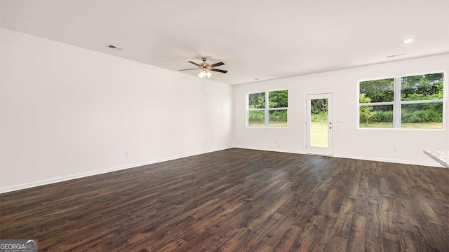 spare room featuring ceiling fan and dark hardwood / wood-style flooring