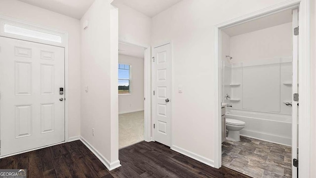 foyer with dark hardwood / wood-style floors