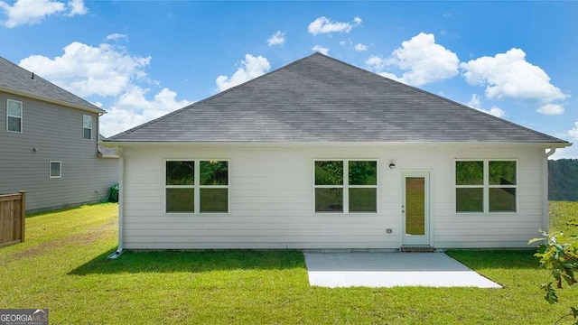 back of property featuring a patio area and a lawn