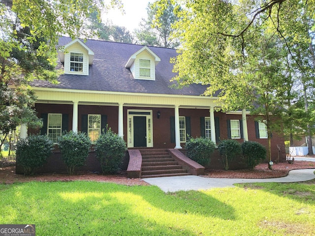 cape cod-style house with a porch and a front yard