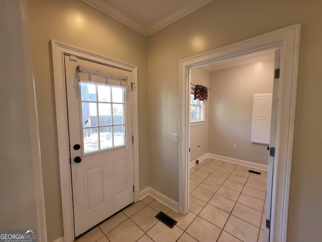 doorway to outside featuring ornamental molding, a healthy amount of sunlight, visible vents, and light tile patterned floors