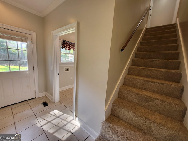 doorway to outside featuring light tile patterned floors, stairs, baseboards, and crown molding