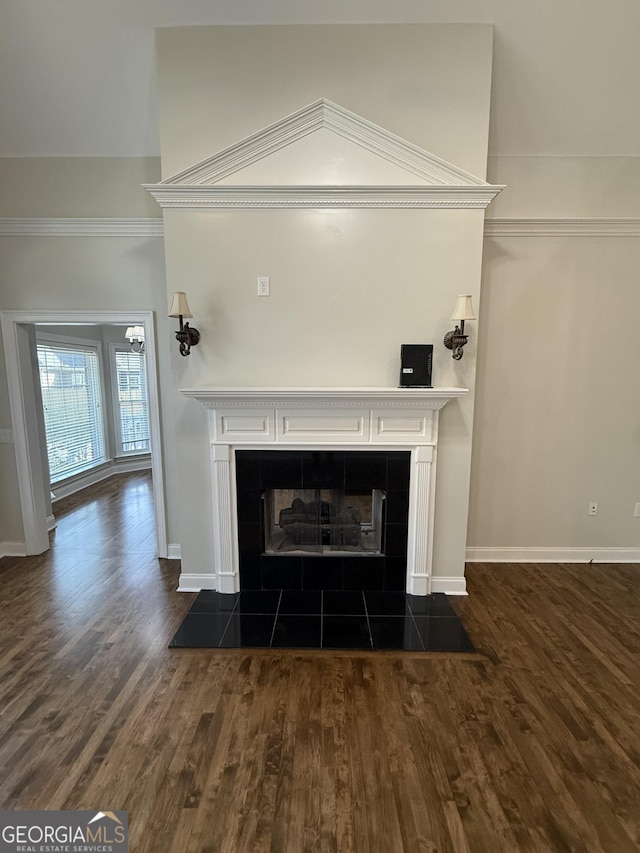 details with a fireplace, baseboards, and wood finished floors