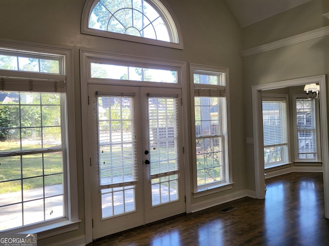 doorway featuring lofted ceiling, visible vents, dark wood-type flooring, and french doors