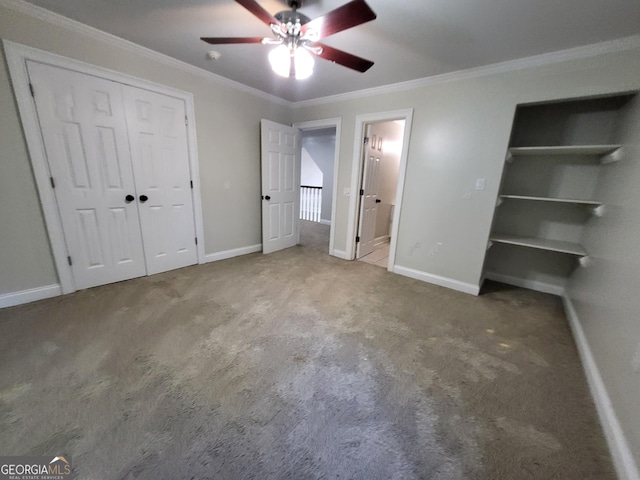 unfurnished bedroom featuring a closet, ornamental molding, carpet flooring, ceiling fan, and baseboards