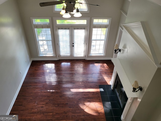 doorway featuring baseboards, dark wood-style flooring, and french doors