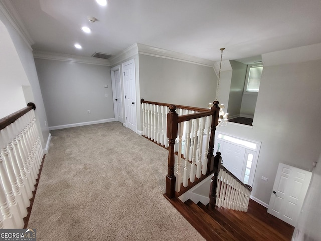 hall featuring visible vents, baseboards, crown molding, an upstairs landing, and recessed lighting