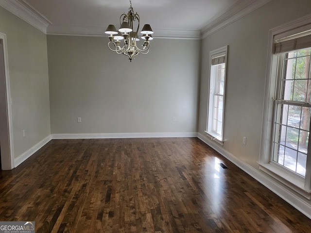 spare room featuring baseboards, dark wood-type flooring, an inviting chandelier, and crown molding