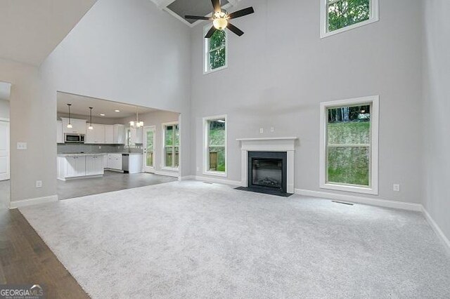 unfurnished room featuring a chandelier, dark hardwood / wood-style floors, and ornamental molding