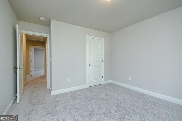 unfurnished bedroom featuring light colored carpet