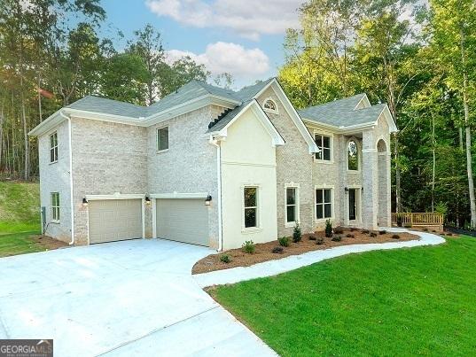 view of front of property featuring a garage and a front lawn