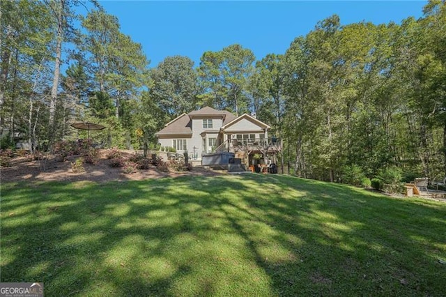 view of front of home with a deck and a front lawn