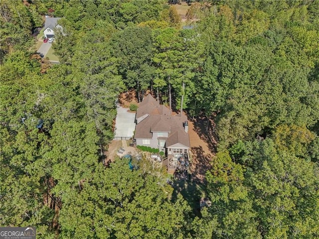 birds eye view of property with a view of trees