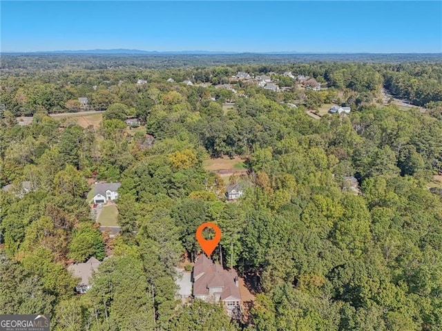 birds eye view of property with a view of trees