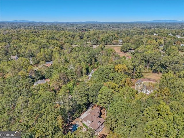 birds eye view of property featuring a view of trees