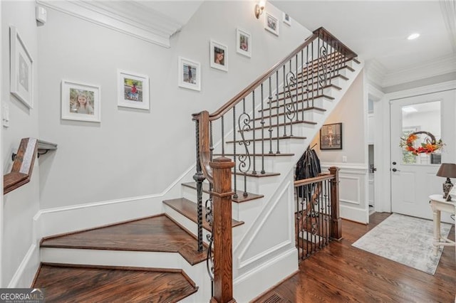 stairs with ornamental molding, recessed lighting, baseboards, and wood finished floors