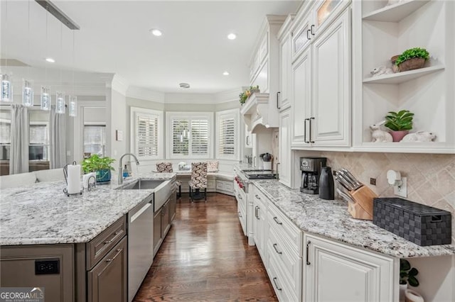 kitchen with crown molding, hanging light fixtures, dishwasher, and white cabinets