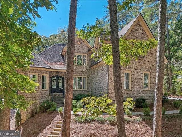 view of front facade featuring french doors and brick siding