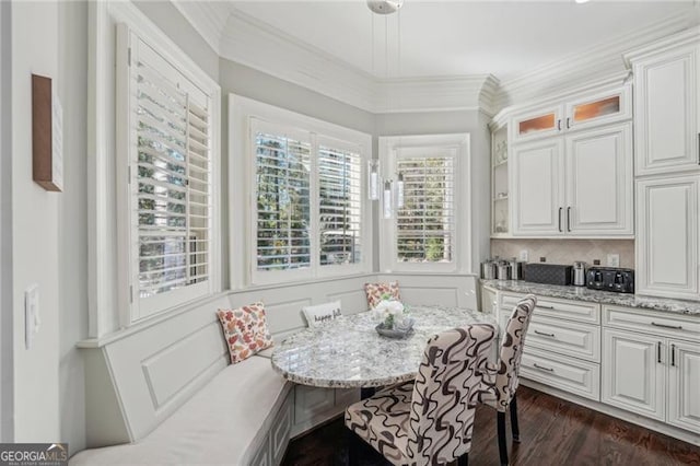 dining area featuring crown molding and dark hardwood / wood-style floors