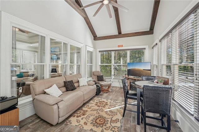 sunroom featuring vaulted ceiling with beams and ceiling fan