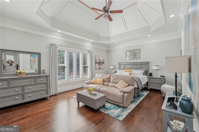 bedroom featuring dark wood-type flooring, a tray ceiling, and ceiling fan