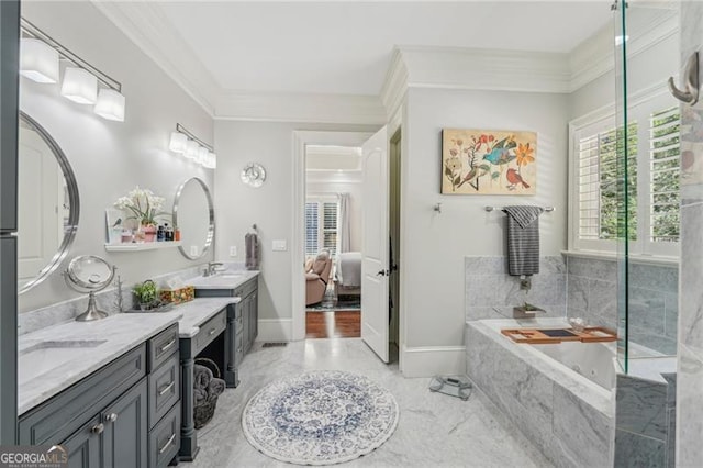 bathroom with vanity, ornamental molding, and a relaxing tiled tub