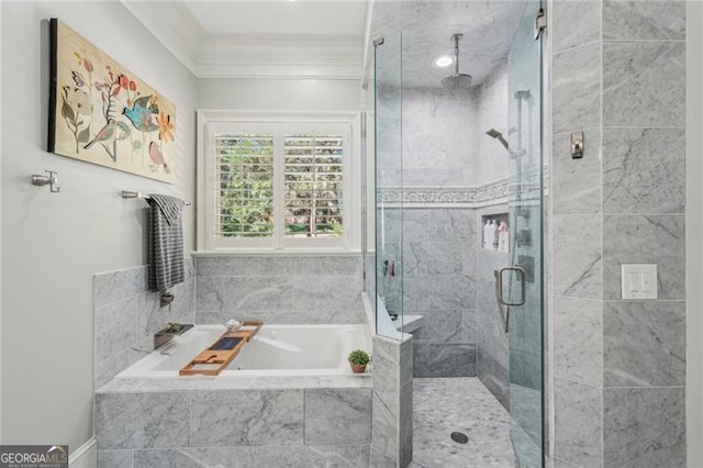 bathroom featuring ornamental molding, a garden tub, and a shower stall