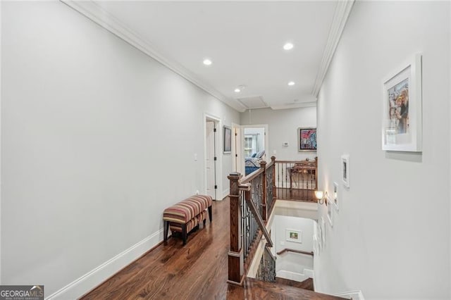 hall with dark wood-type flooring and crown molding