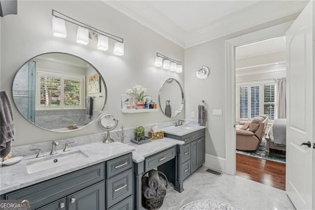 ensuite bathroom featuring double vanity, crown molding, a sink, and ensuite bathroom